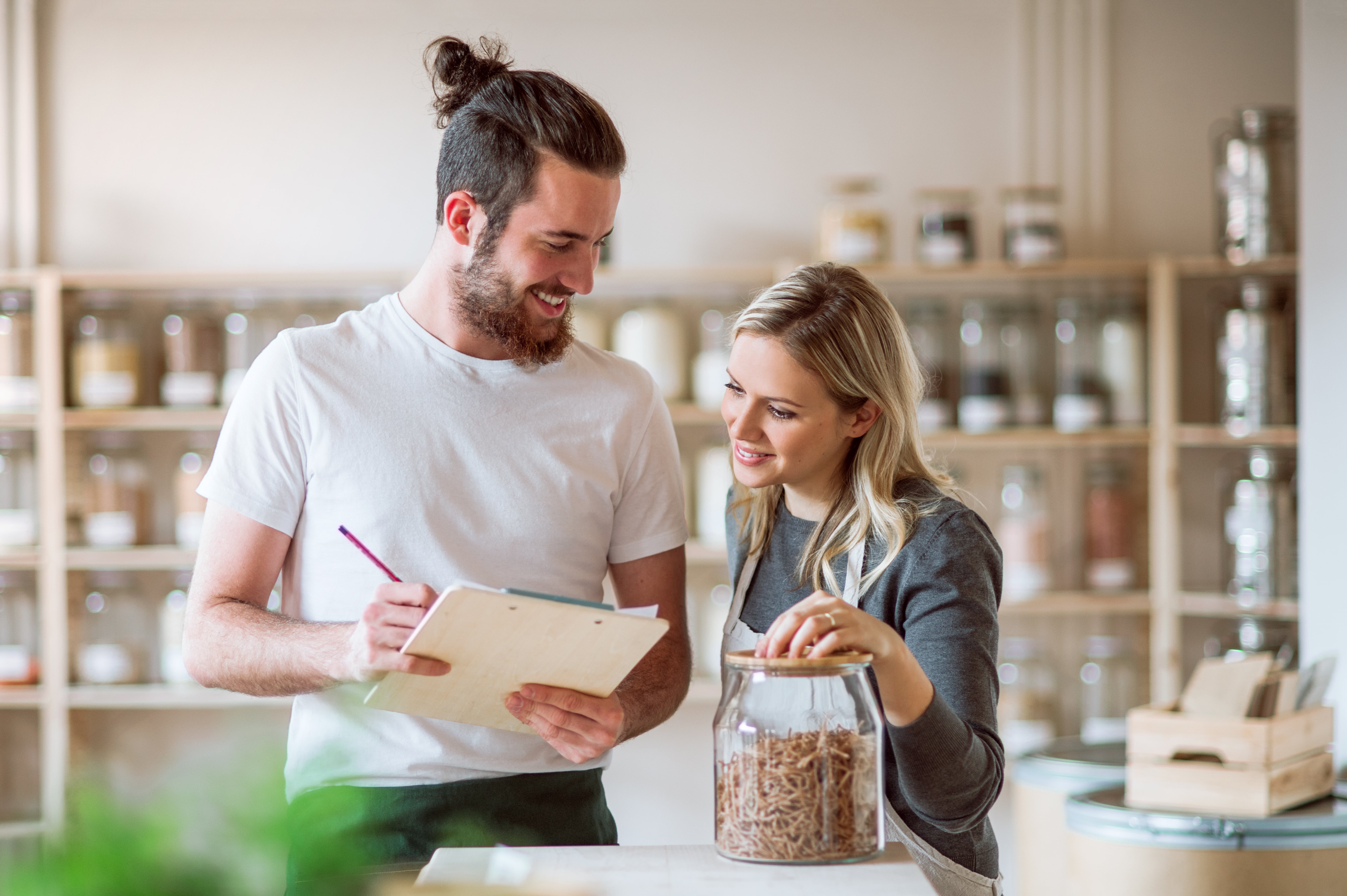 two-shop-assistants-standing-in-zero-waste-shop-AV8TSCK-1